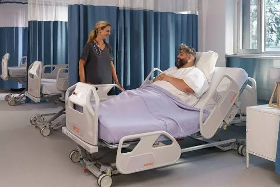 An example of a hospital bed with the curtain open.