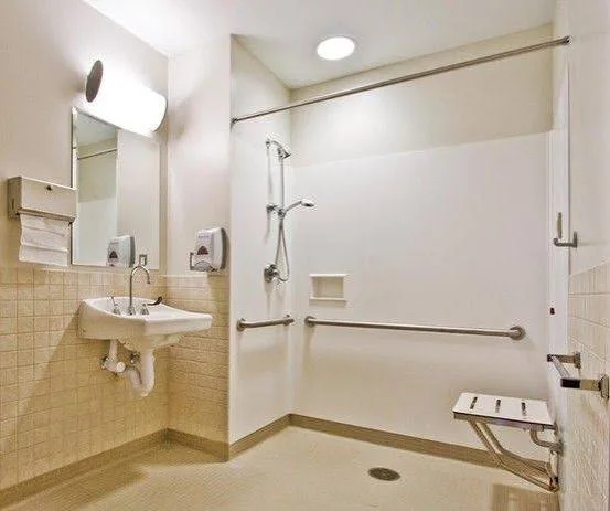 An example of a hospital washroom with a shower and seat.