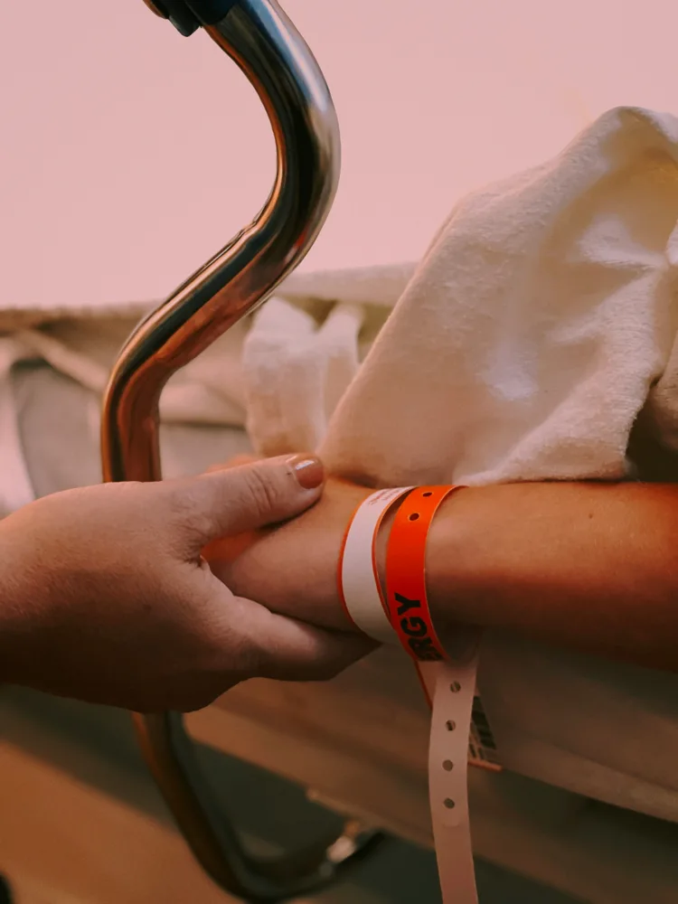 An example of hospital wristbands on an adult wrist.